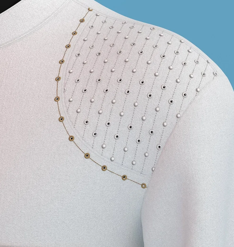 Gold beadwork detailing across the shoulder of a cream garment