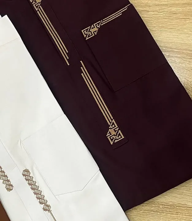 Gold geometric embroidery on a burgundy kaftan placket